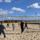 The Brightec team playing volleyball on the beach
