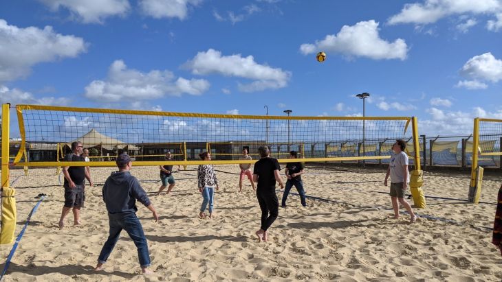 The Brightec team playing volleyball on the beach
