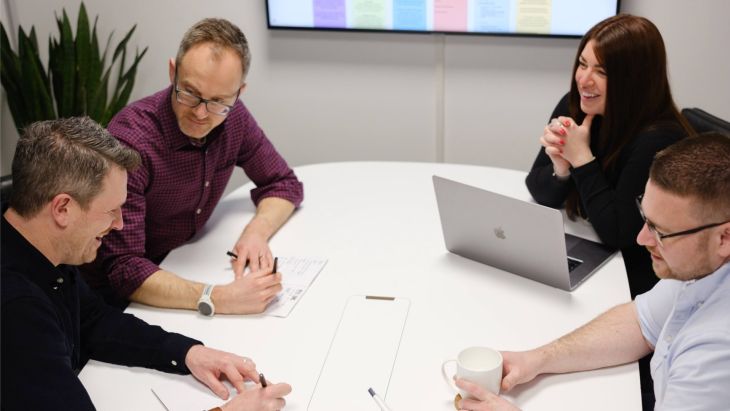 The leadership team enjoy a discussion at the table