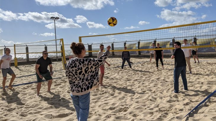 The Brightec team playing volleyball on the beach