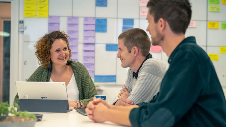 Chris, Jonny and Caz discussing e-commerce app development in the bright office