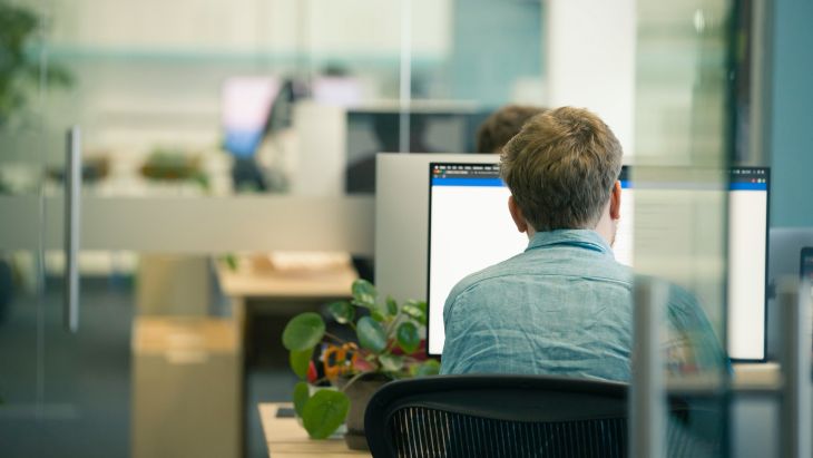 Rhys working at his desk in the Brightec office