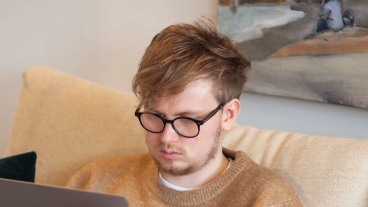 Rhys working on a laptop