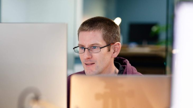 A head shot of Chris looking at a screen