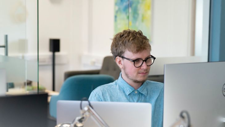 A photo of Rhys working at his desk