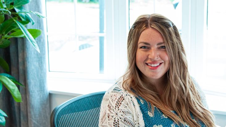 Georgia smiling at her desk