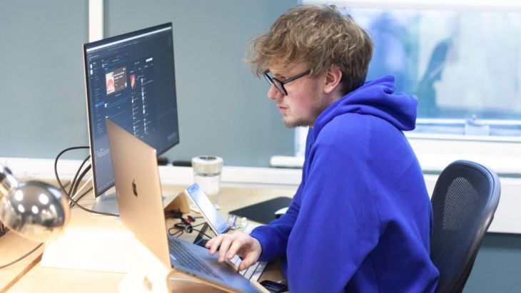 Rhys working at his desk