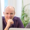 A photo of Nick and Alistair working at a desk together