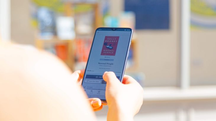 A photo of a lady testing the functionality of an app on her phone