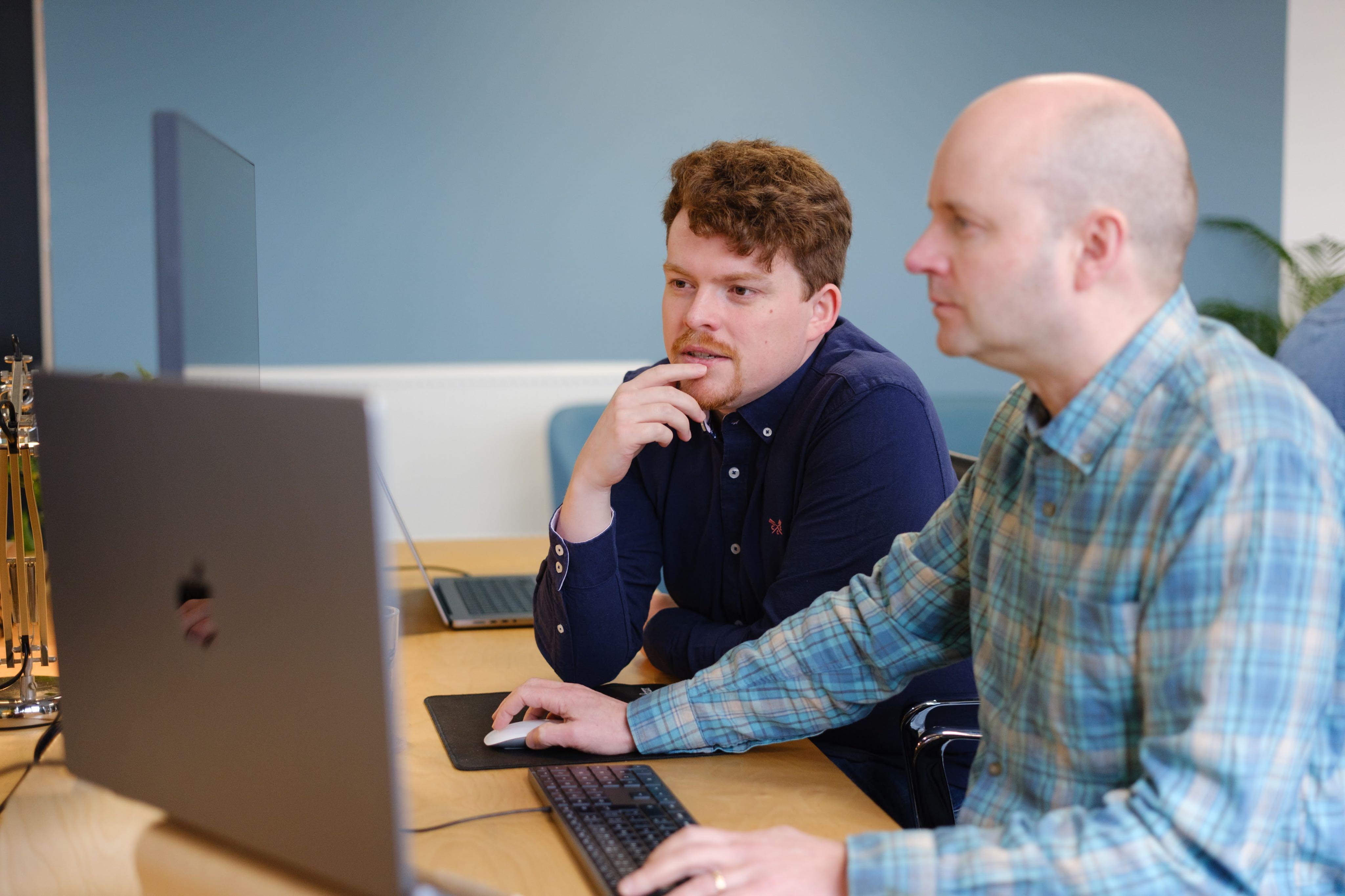 2 engineers working at a laptop