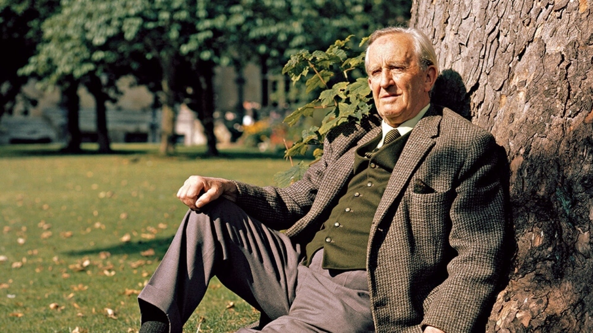 J R R Tolkein sitting by a tree