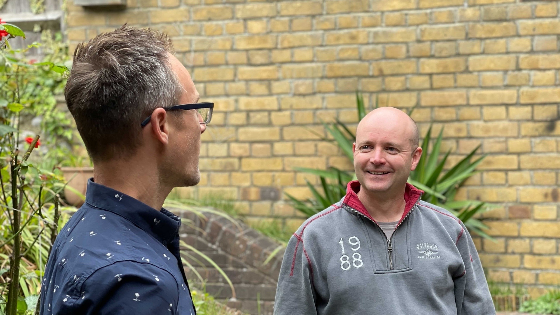 Nick and James talking together in the garden