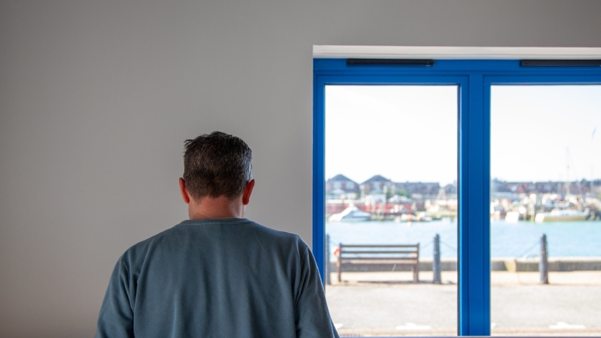 A photo of Andy looking out the window with his back to the camera